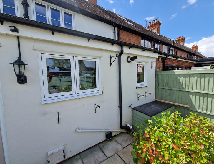 Cottage with white-framed windows