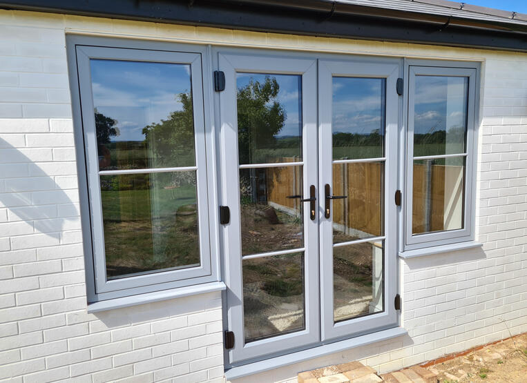 Modern white-framed glass doors on residential exterior